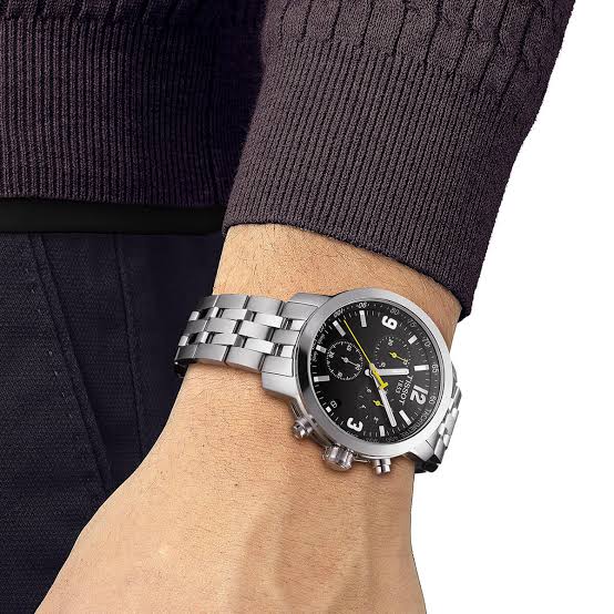 Tissot PRC 200 chronograph watch worn on wrist with two-tone steel bracelet and black dial