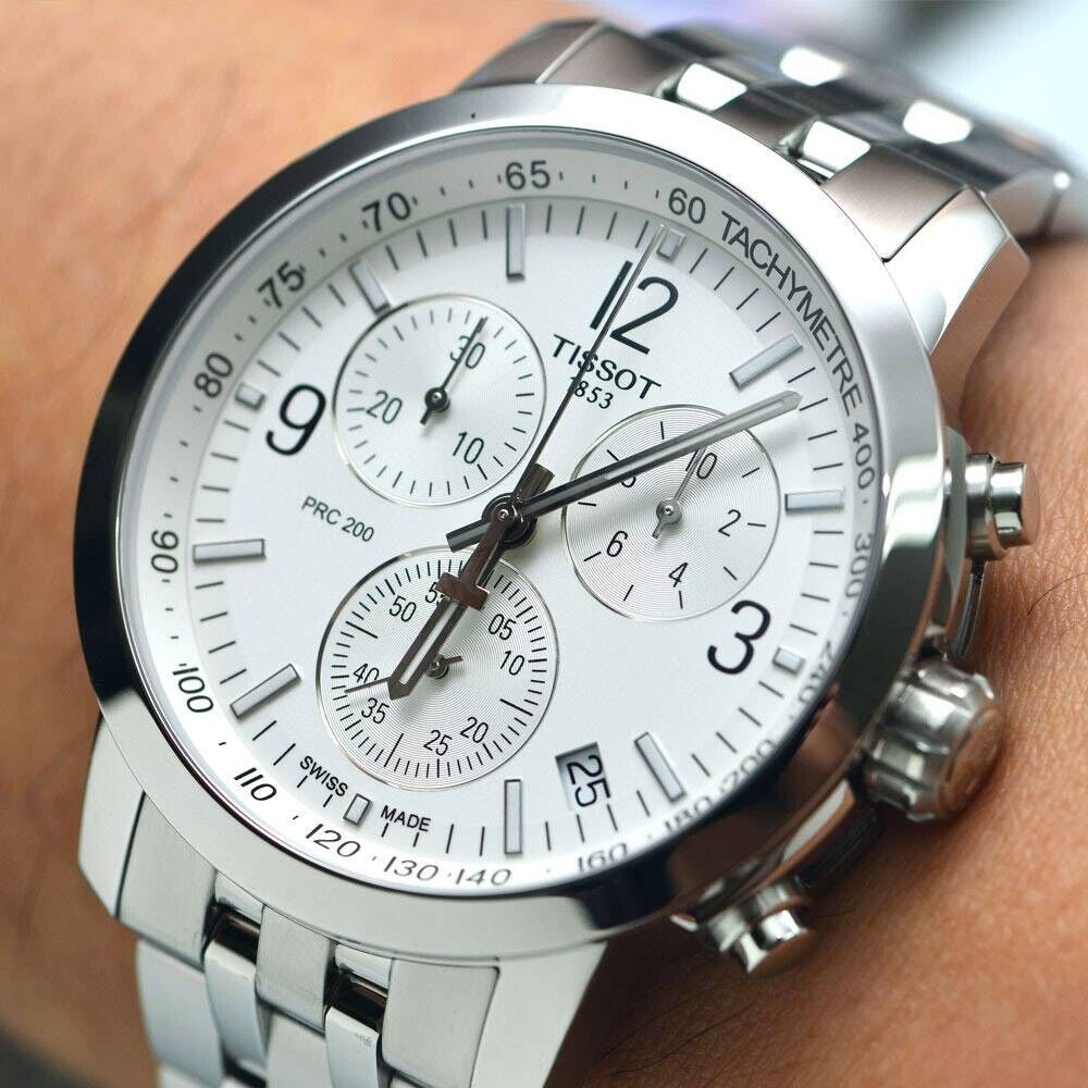 Tissot PRC 200 Chronograph watch worn on wrist showing silver dial and bracelet