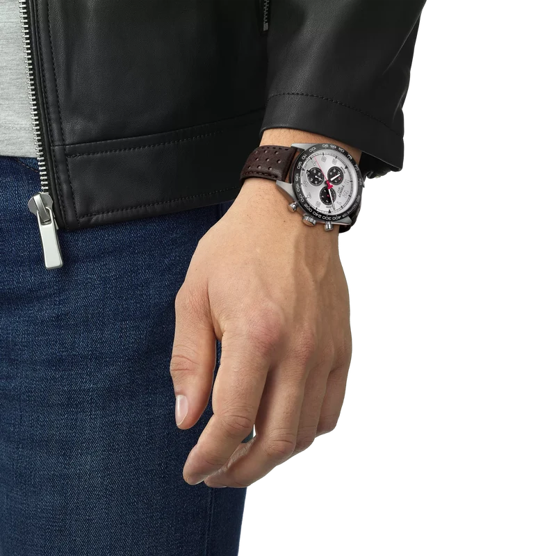 Tissot PRS 516 chronograph worn on wrist showing silver dial and brown leather strap