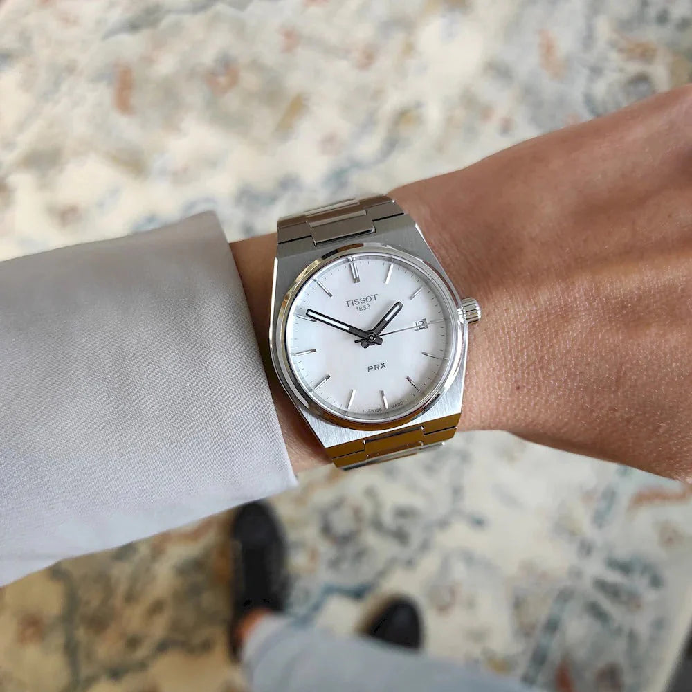 Tissot PRX 35mm women's watch worn on wrist with white mother of pearl dial