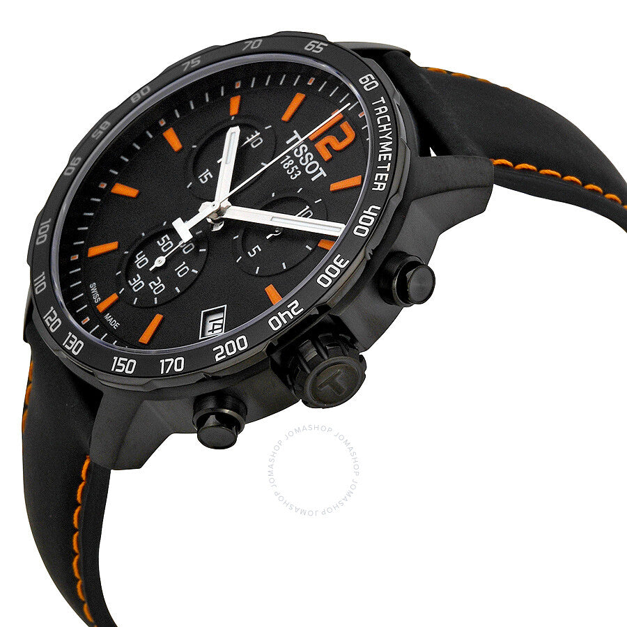 Tissot Quickster on wrist showing black leather strap with orange stitching and chronograph subdials