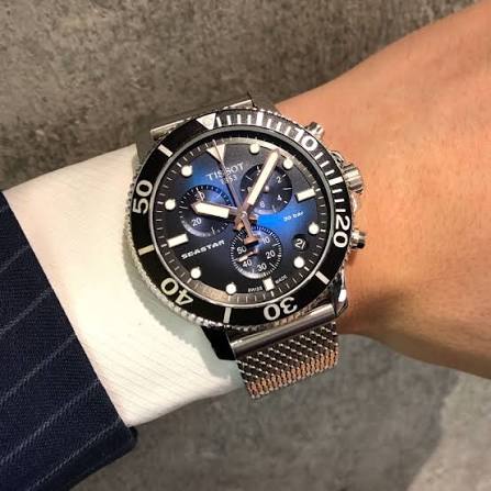Tissot Seastar 1000 chronograph watch worn on wrist with stainless steel mesh strap