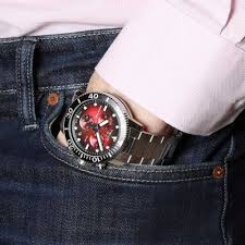 Tissot Seastar 1000 chronograph red dial watch worn on wrist with silver bracelet