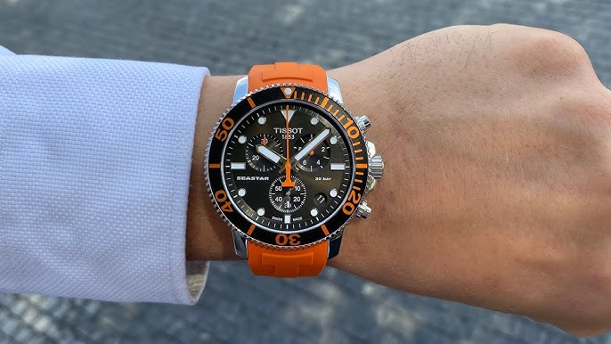 Tissot Seastar 1000 chronograph watch worn on wrist with orange strap and black dial