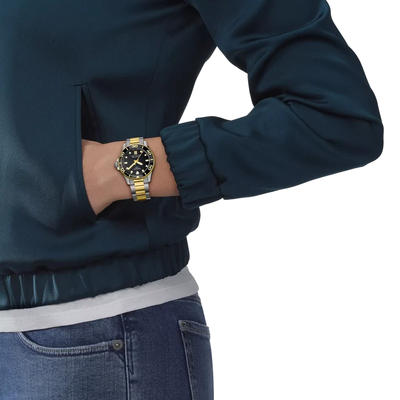 Tissot Seastar 1000 two-tone watch worn on wrist showing black dial and mixed metal band