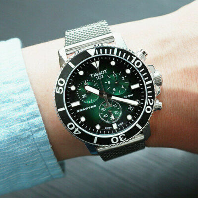 Tissot Seastar 1000 chronograph watch worn on wrist showing green dial and chronograph subdials