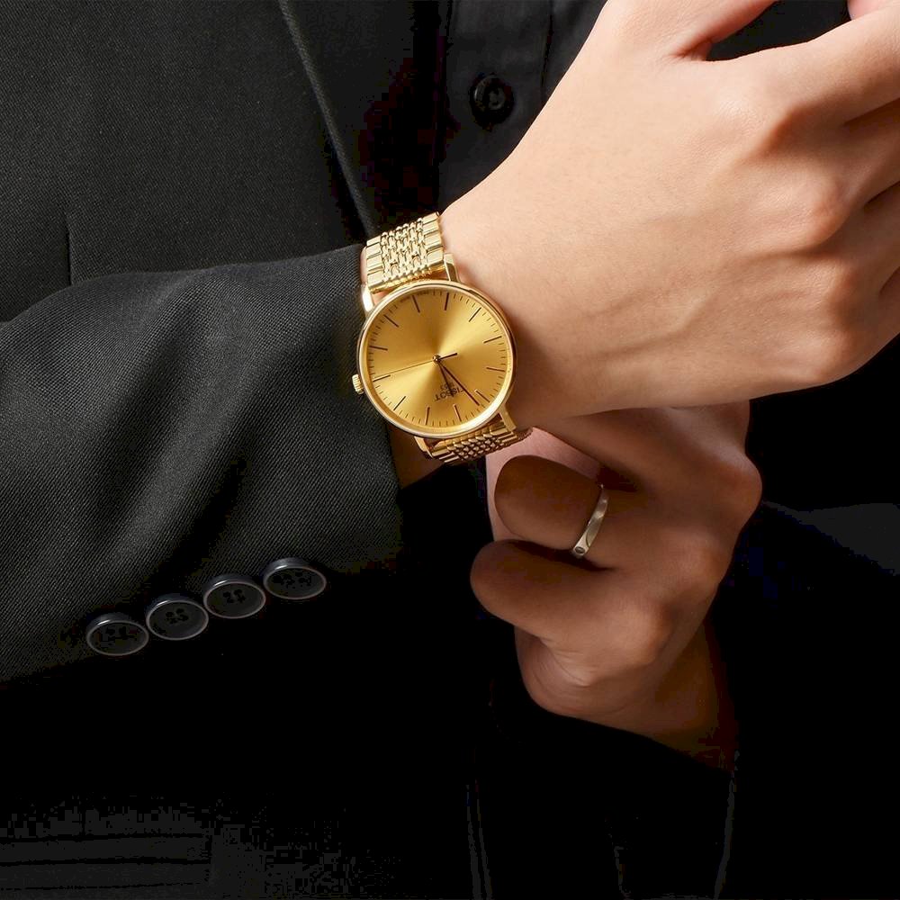 Tissot T-Classic ladies watch worn on wrist showing gold dial and champagne color