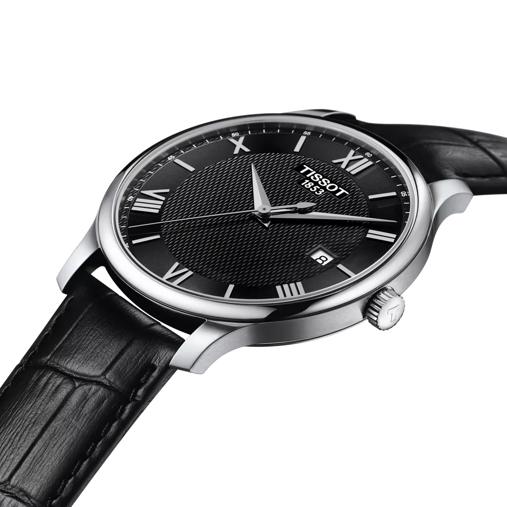 Angled view of Tissot watch showing black dial with Roman numerals, stainless steel case and black leather strap