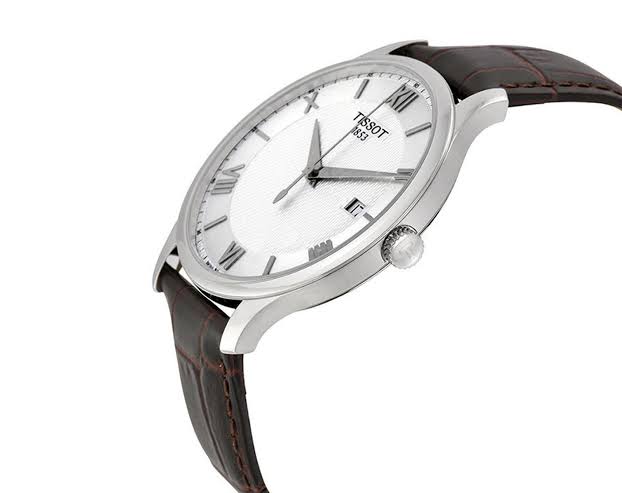 Side angle view of Tissot T-Classic Tradition watch showing silver case and brown strap profile
