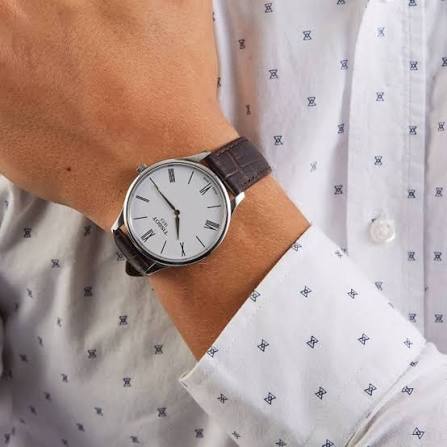 Tissot T Classic Tradition watch worn on wrist with white dial and brown leather strap
