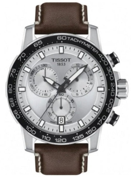 Tissot chronograph watch with silver dial, black bezel, and brown leather strap