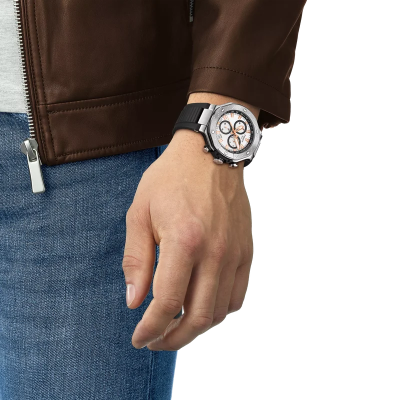 Tissot T-Race chronograph on wrist with white dial, stainless steel case, and black silicone strap