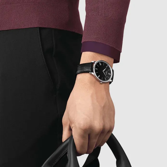 Tissot Tradition 5.5 women's watch worn on wrist with black dial and leather strap