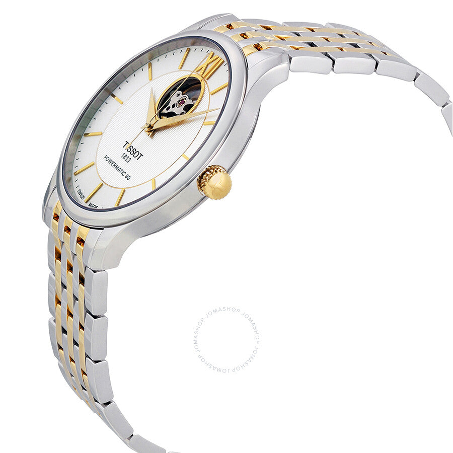 Side angle view of Tissot Tradition Powermatic 80 watch showing two-tone bracelet and open heart dial