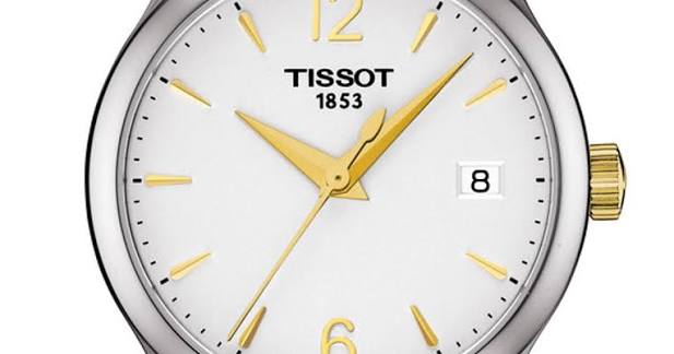 Tissot Tradition watch dial detail with gold indices and hands