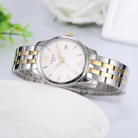Tissot Tradition two-tone watch on wrist showing silver and gold bracelet