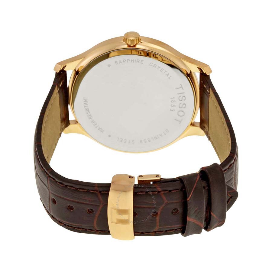 Tissot Tradition watch caseback showing sapphire crystal and warranty details on gold case