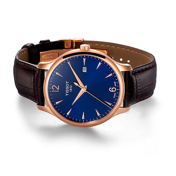 Tissot Tradition watch worn on wrist with blue dial and brown leather strap
