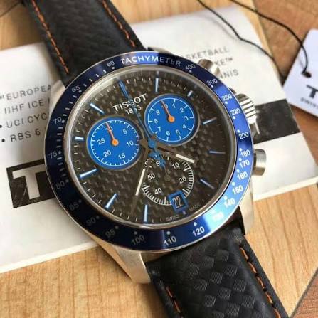 Tissot V8 Alpine Carbon chronograph watch displayed on black carbon leather strap with blue subdials