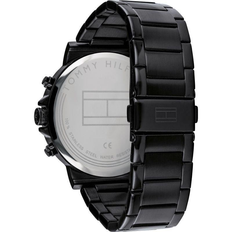 Watch caseback showing Tommy Hilfiger branding and specifications on steel back plate