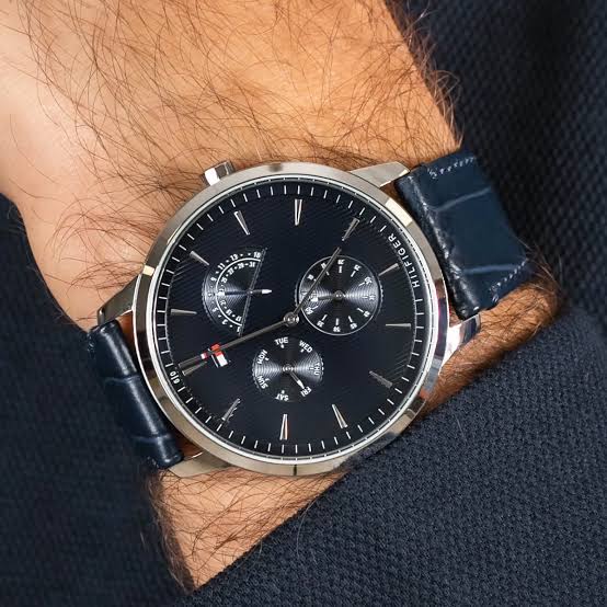 Tommy Hilfiger 1710387 watch worn on wrist, blue dial and navy leather strap visible
