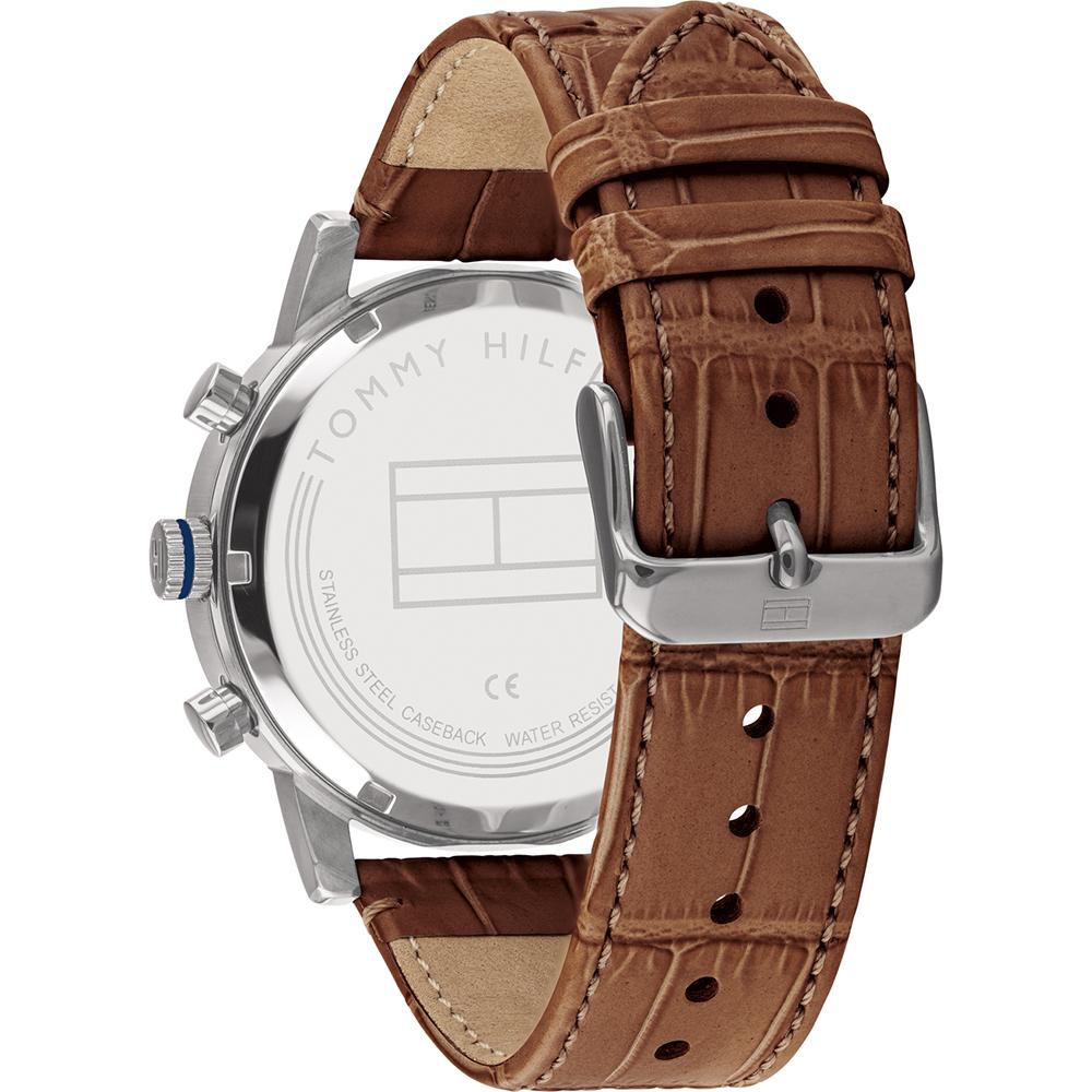Detail of brown leather crocodile-textured strap with adjustment holes and beige suede inner lining