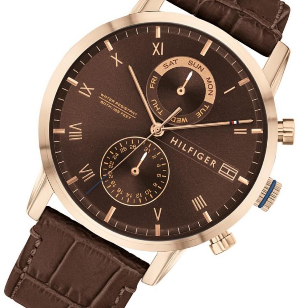 Angled view of Tommy Hilfiger chronograph watch featuring brown leather strap and rose gold case details
