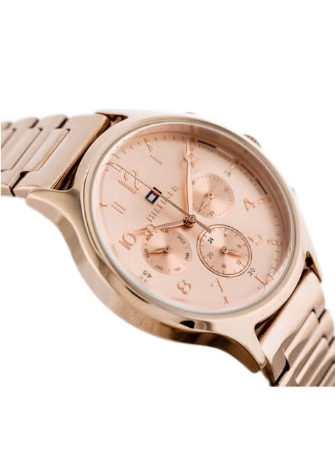 Tommy Hilfiger women's watch at angle showing pink dial with subdials and rose gold bracelet