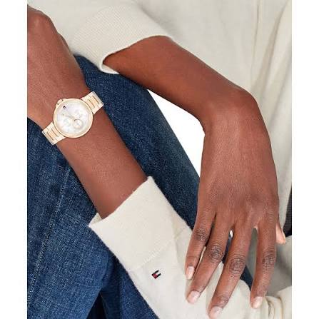 Tommy Hilfiger gold watch on wrist with white dial and gold steel bracelet