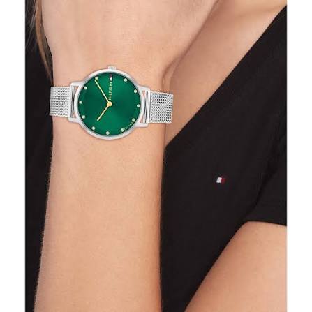 Tommy Hilfiger green dial watch worn on wrist with silver mesh strap