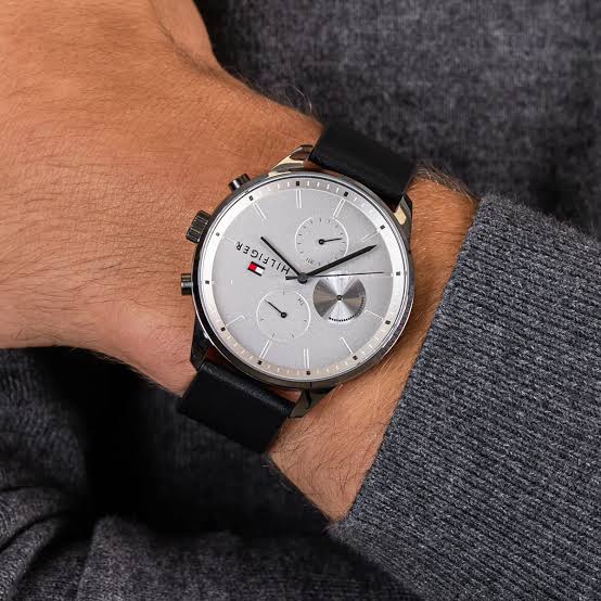 Tommy Hilfiger watch worn on wrist with white dial and black silicone strap