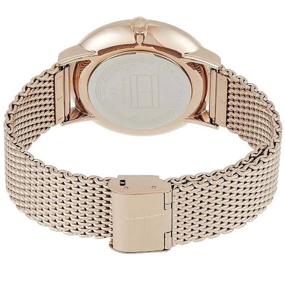 Tommy Hilfiger watch caseback showing rose gold mesh strap and fold-over clasp closure