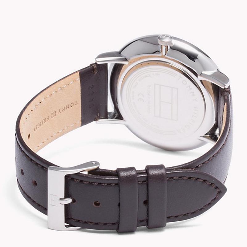 Tommy Hilfiger watch caseback showing silver-tone case and brown leather strap with buckle