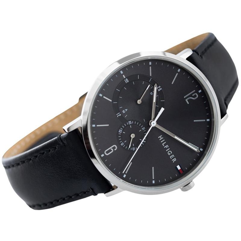 Tommy Hilfiger watch angled side view displaying silver case, black dial, and leather strap