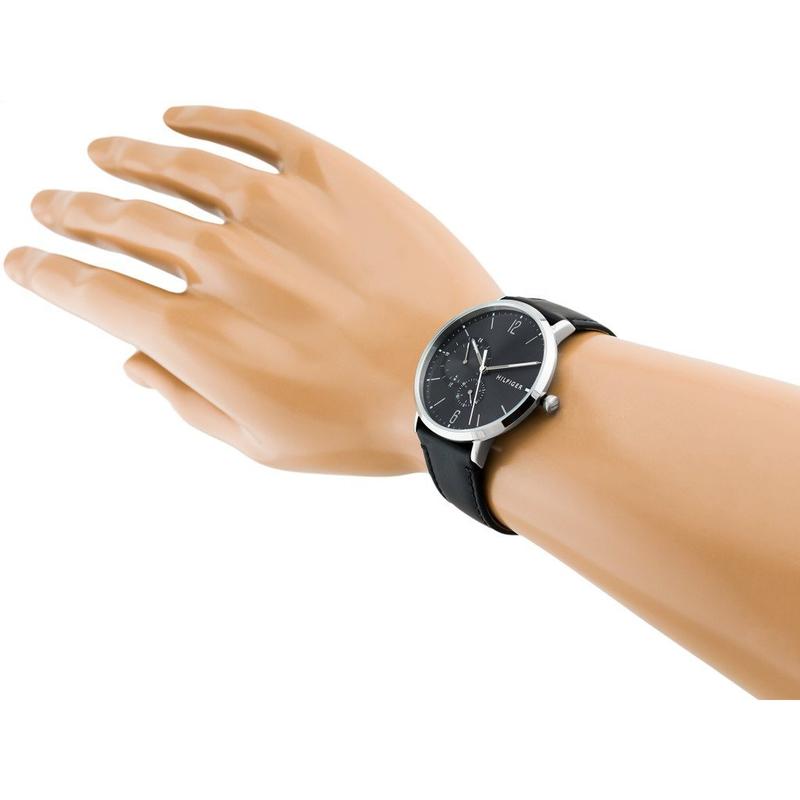 Tommy Hilfiger black dial watch on wrist with silver case and black leather strap