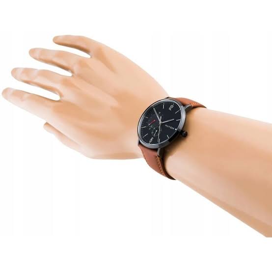 Tommy Hilfiger 1791510 men's watch worn on wrist with black dial and brown leather strap