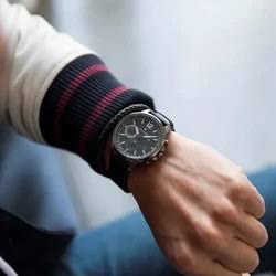 Tommy Hilfiger quartz watch on wrist with black dial and leather strap