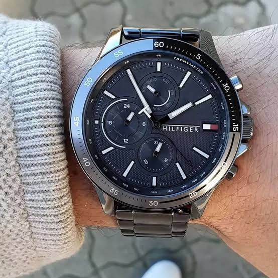 Tommy Hilfiger 1791719 chronograph watch worn on wrist with grey dial and steel bracelet