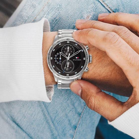 Tommy Hilfiger 1791805 chronograph watch worn on wrist with black dial and steel bracelet