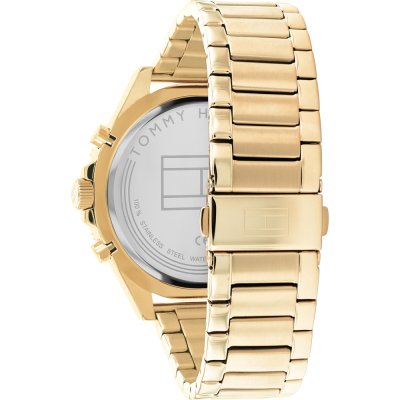 Gold watch caseback showing Tommy Hilfiger branding and engraving