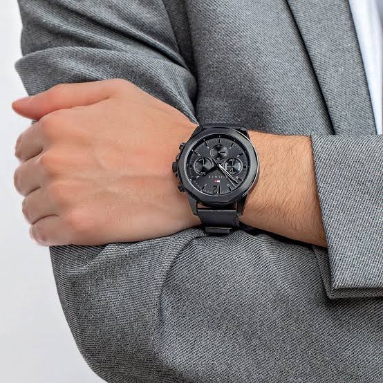 Tommy Hilfiger black chronograph watch worn on wrist with gray shirt