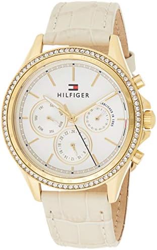 Tommy Hilfiger Ari watch showing gold case, white chronograph dial, and cream leather band