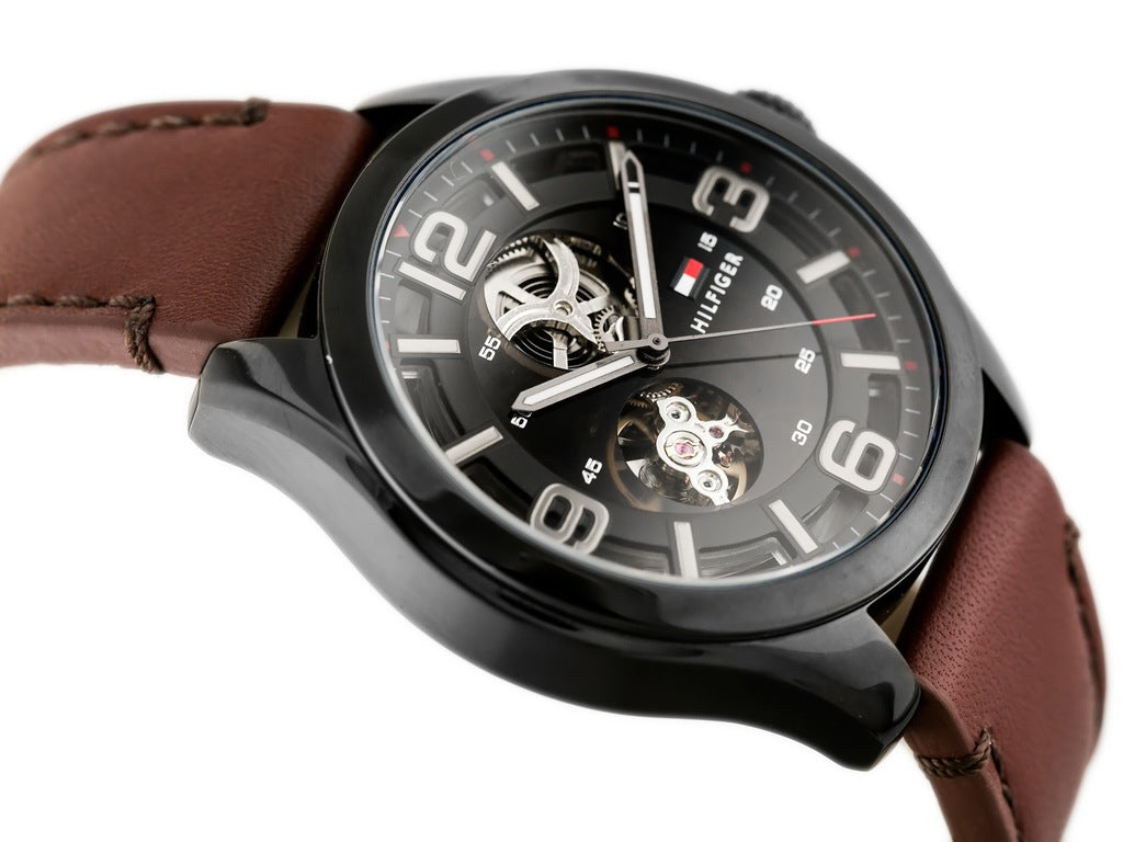 Side view of Tommy Hilfiger Bruce watch with visible skeleton movement and brown leather strap