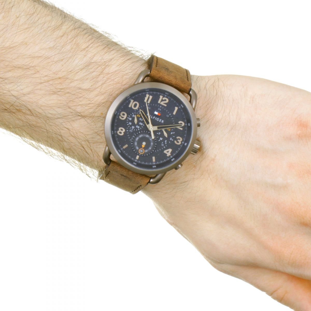 Tommy Hilfiger chronograph watch worn on wrist with black dial and brown leather strap