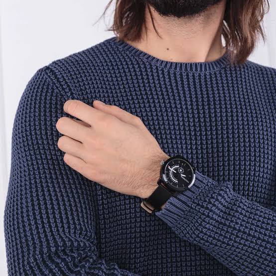 Tommy Hilfiger Denim black watch worn on wrist with navy sweater