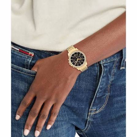 Tommy Hilfiger Haven ladies watch worn on wrist with black chronograph dial and gold bracelet