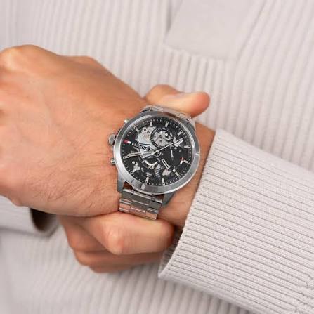 Tommy Hilfiger HENRY watch worn on wrist showing silver bracelet and black dial