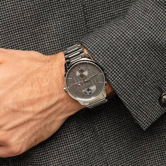 Tommy Hilfiger Hunter watch worn on wrist showing dark gray dial and silver bracelet