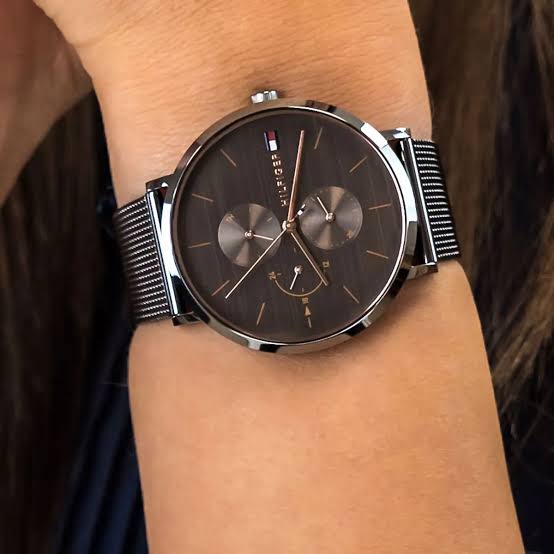 Tommy Hilfiger Jenna multifunction watch on wrist showing grey dial and mesh strap