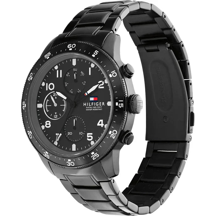 Tommy Hilfiger Jimmy watch at angle showing black chronograph dial and metal bracelet